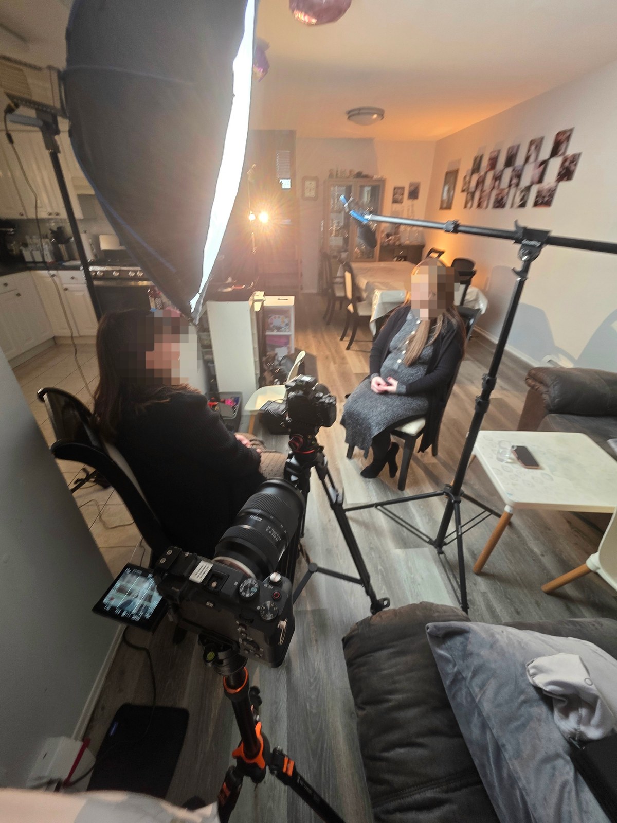 Cameras, lighting, and a boom microphone set up for a filmed conversation